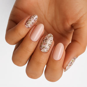 Nude glossy semi-cured gel nails with mixed ditsy floral accent nails, oval shape