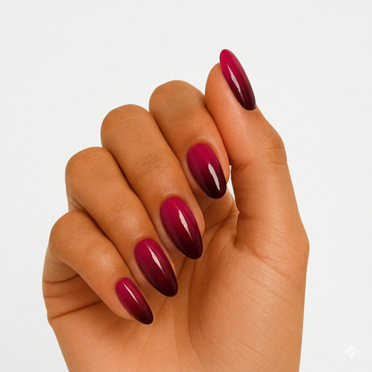 Pink to burgundy ombre gel nail wraps on hand showing glossy gradient finish