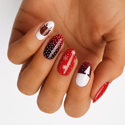 Red and white nail wraps with reindeer, snowflakes, polka dots and Christmas tree design