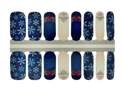 Navy blue nail wraps with white snowflakes, red bows and "Merry Christmas" text