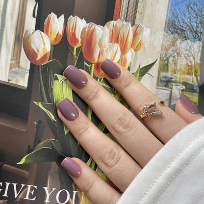 Mauve pink glossy semi-cured gel nail wraps on short square nails, solid color.