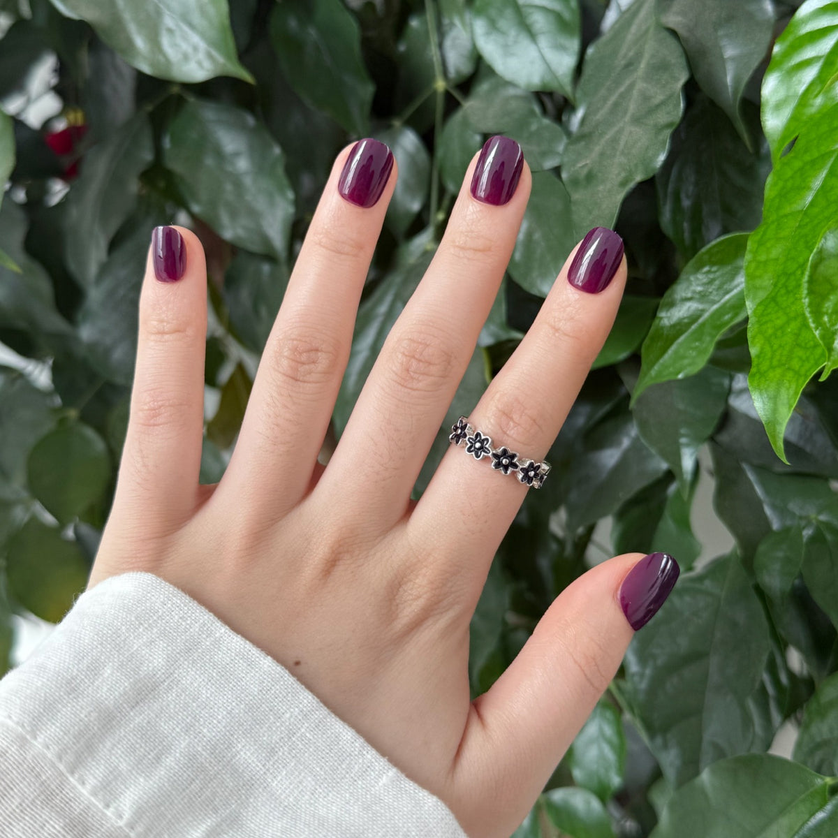 Short square soft gel press-on nails in glossy deep plum, solid colour finish