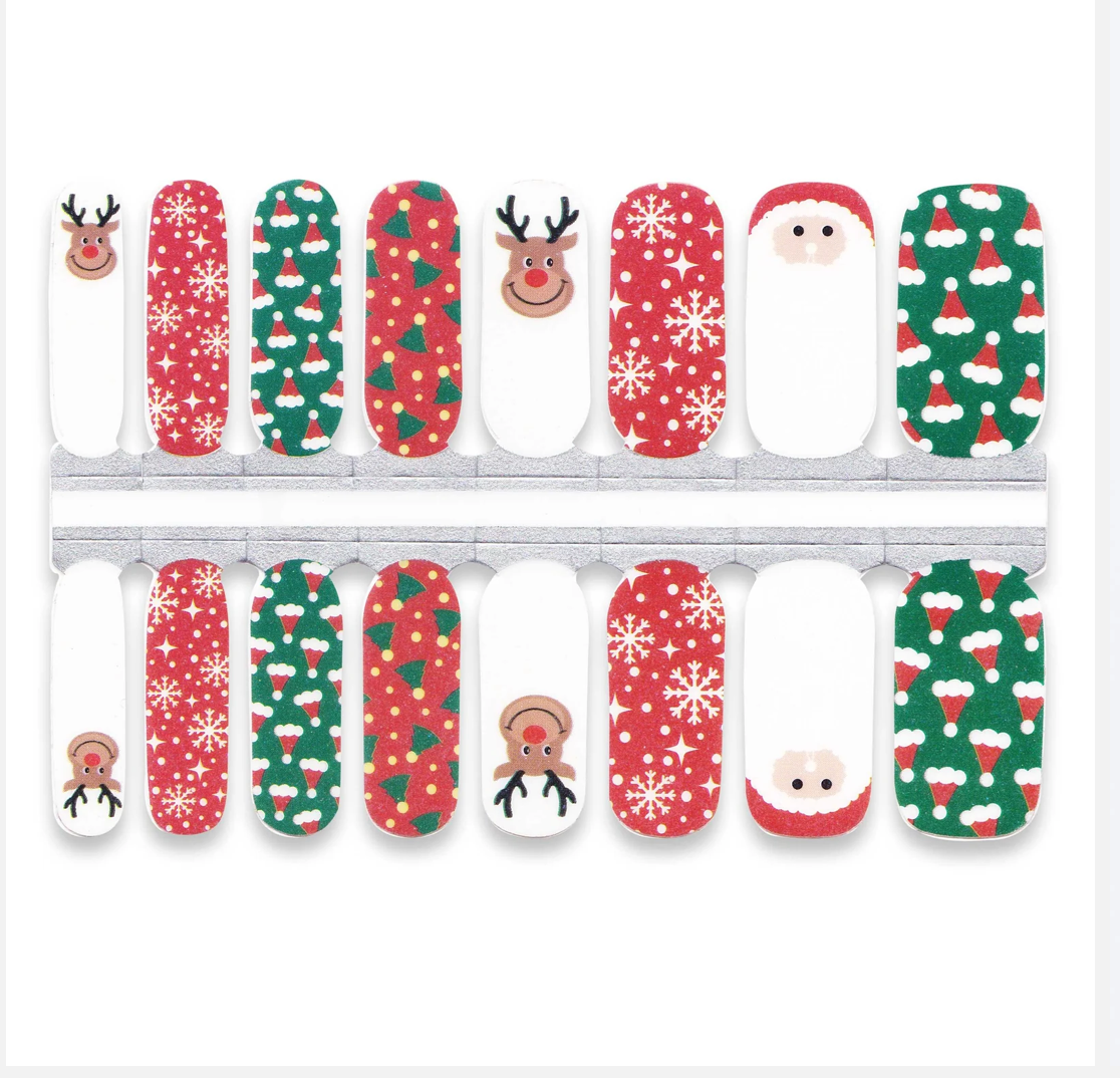 Holy Classics nail wraps with reindeer, Santa, snowflake and tree motifs on red, green and white