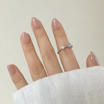 Mauve pink glossy semi-cured gel nail wraps on short almond-shaped nails.