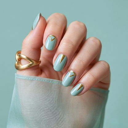 Sage green semi-cured gel nail wraps with gold triangle accent at cuticle