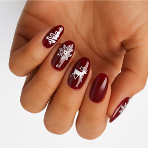 Deep red glossy nail wraps with white Christmas tree, snowflake and reindeer designs