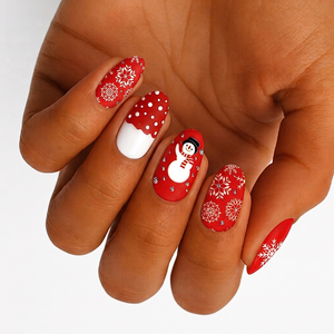 Red nail wraps with white snowflakes, polka-dot cuff, and snowman design, matte finish.
