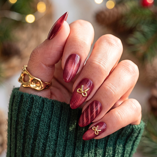 Gift Wrapped soft gel press-on nails, deep red cat-eye shimmer with gold bow charms