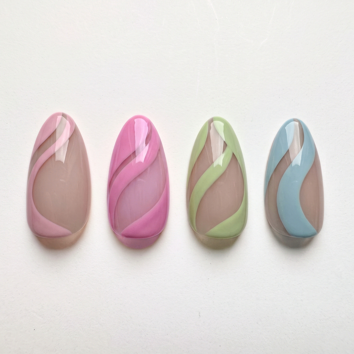 Soft gel press-ons, nude base with pink, magenta, green and blue swirl stripes, glossy finish