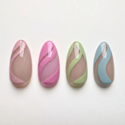 Soft gel press-ons, nude base with pink, magenta, green and blue swirl stripes, glossy finish
