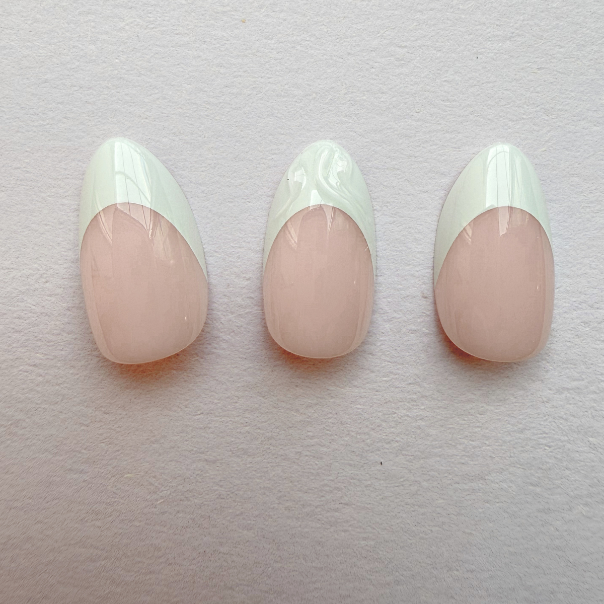 Glossy press-on nails, nude base with mint green French tip design