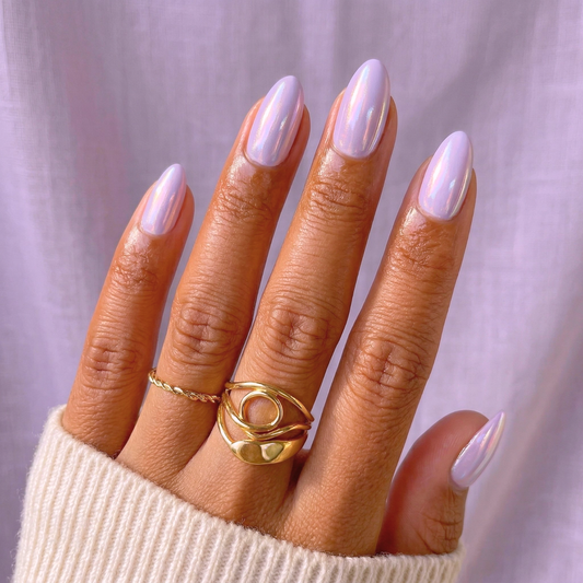 Lilac glazed press-on nails in short almond shape on hand with iridescent finish