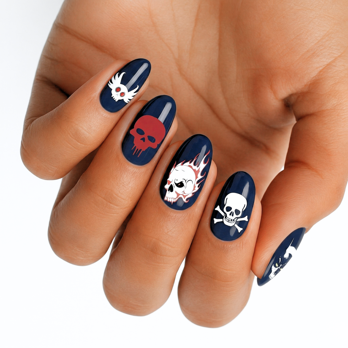 Black nail wraps with white skull and crossbones gothic design on hand
