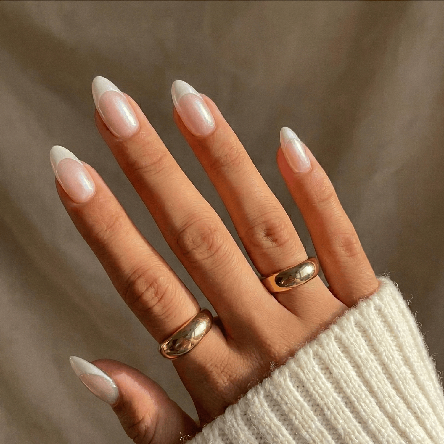 Pearly white French tip semi-cured gel nail wraps on almond-shaped nails
