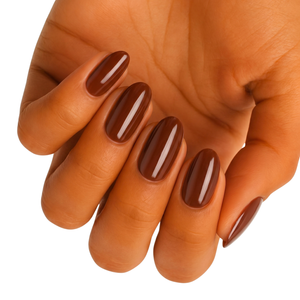 Hand displaying glossy chocolate brown gel nail wraps in warm nude tone for at-home manicure