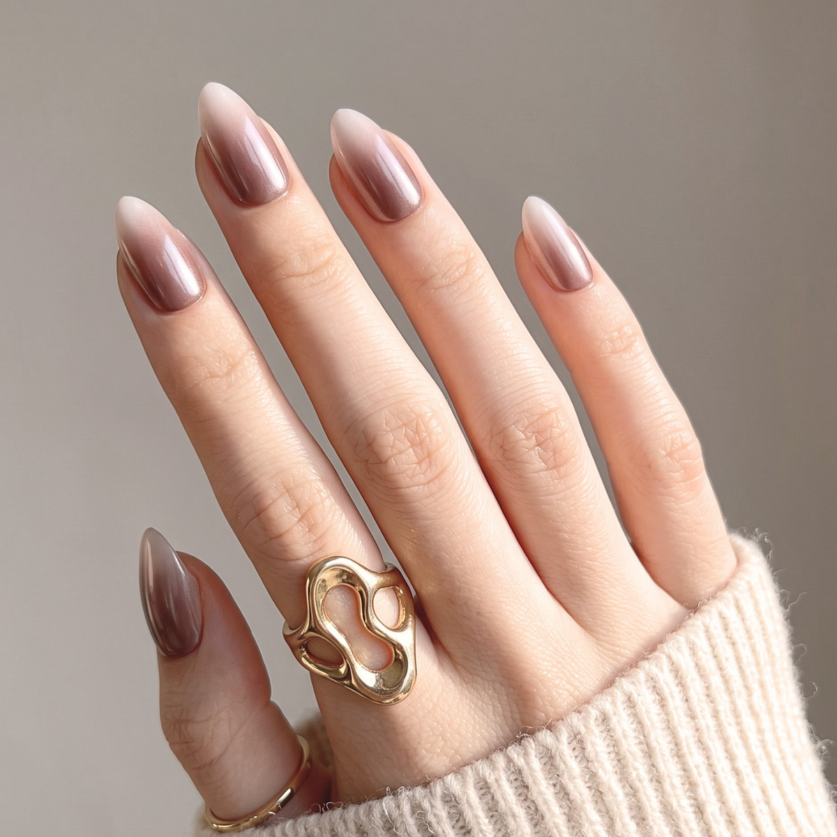 Almond press-on nails with mauve-brown chrome ombré fading to sheer nude tips