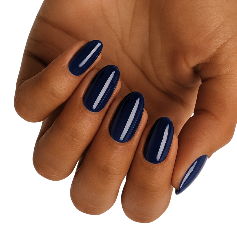 Deep navy blue glossy nail wraps on hand showing professional manicure finish