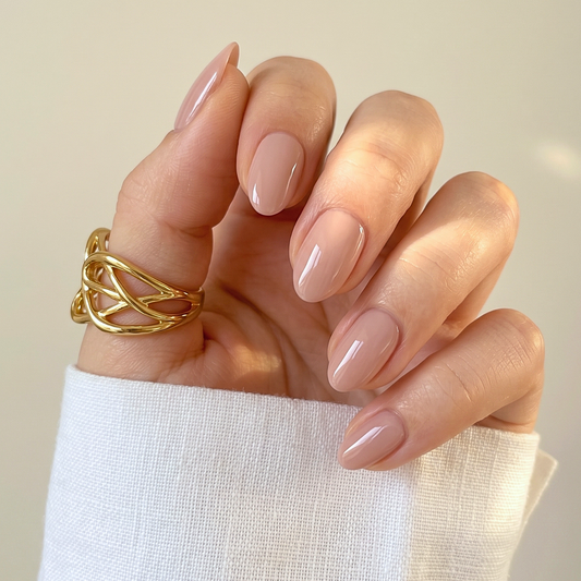 Glossy nude pink semi-cured gel nail wraps on almond-shaped nails
