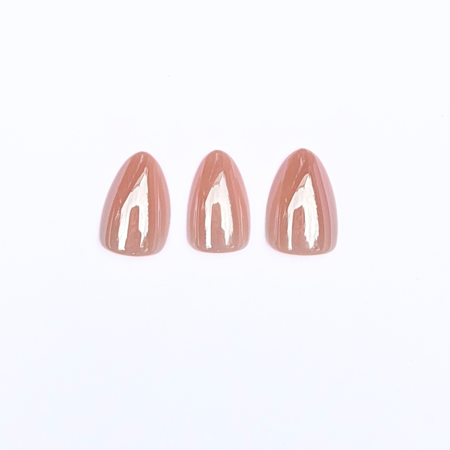 Glossy tan-brown almond press-on nails, solid milky nude semi-cured gel finish