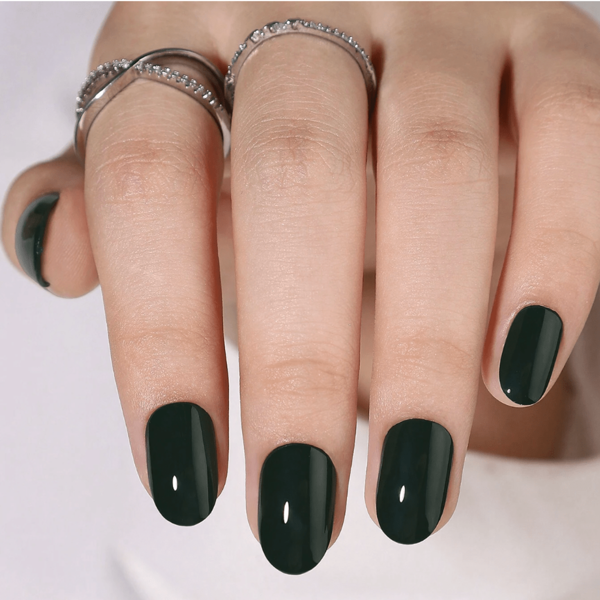 Dark forest green glossy semi-cured gel nail wraps on short round nails