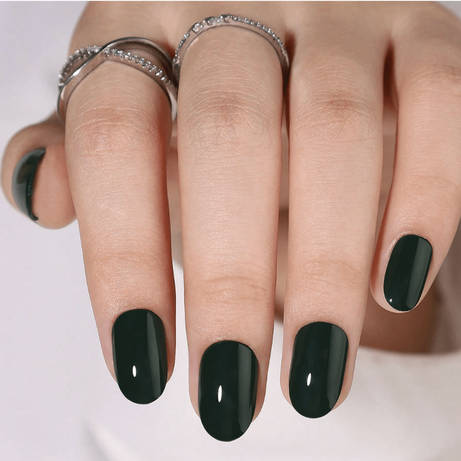 Dark forest green glossy semi-cured gel nail wraps on short round nails