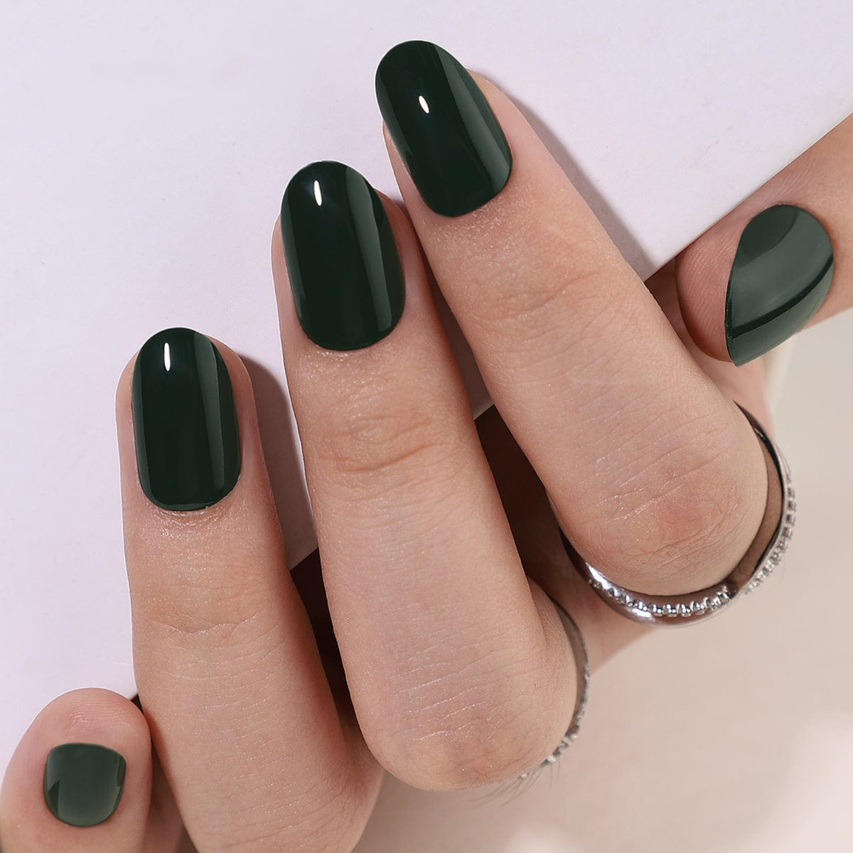 Dark forest green glossy semi-cured gel nail wraps, short round almond shape