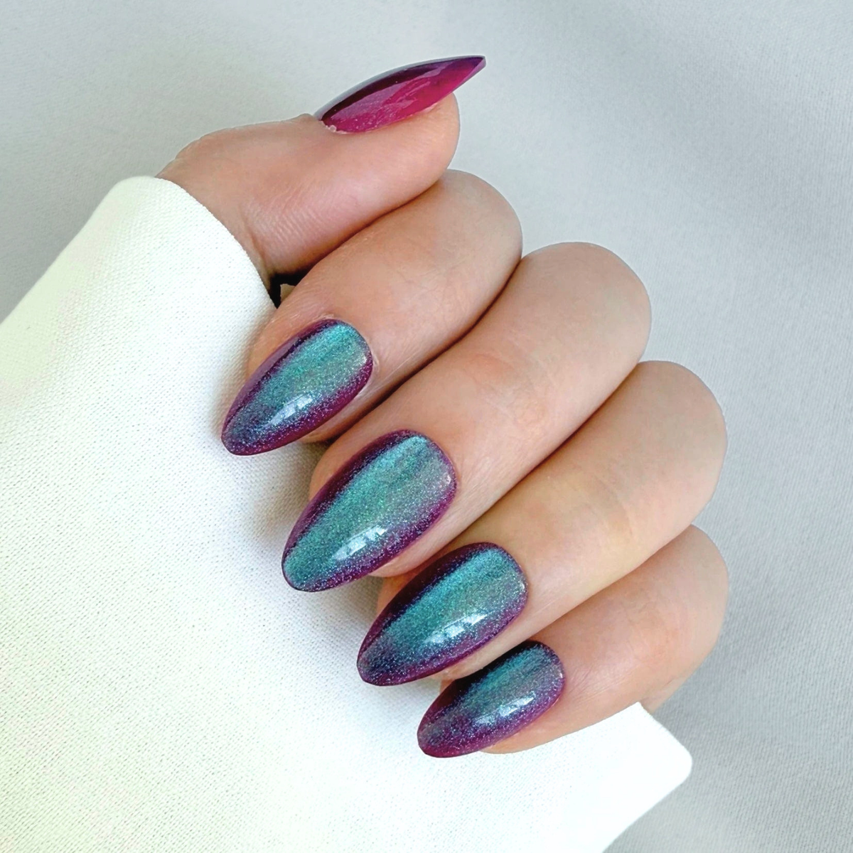 Short almond soft gel press-ons, purple-pink cat's eye shimmer with teal shift