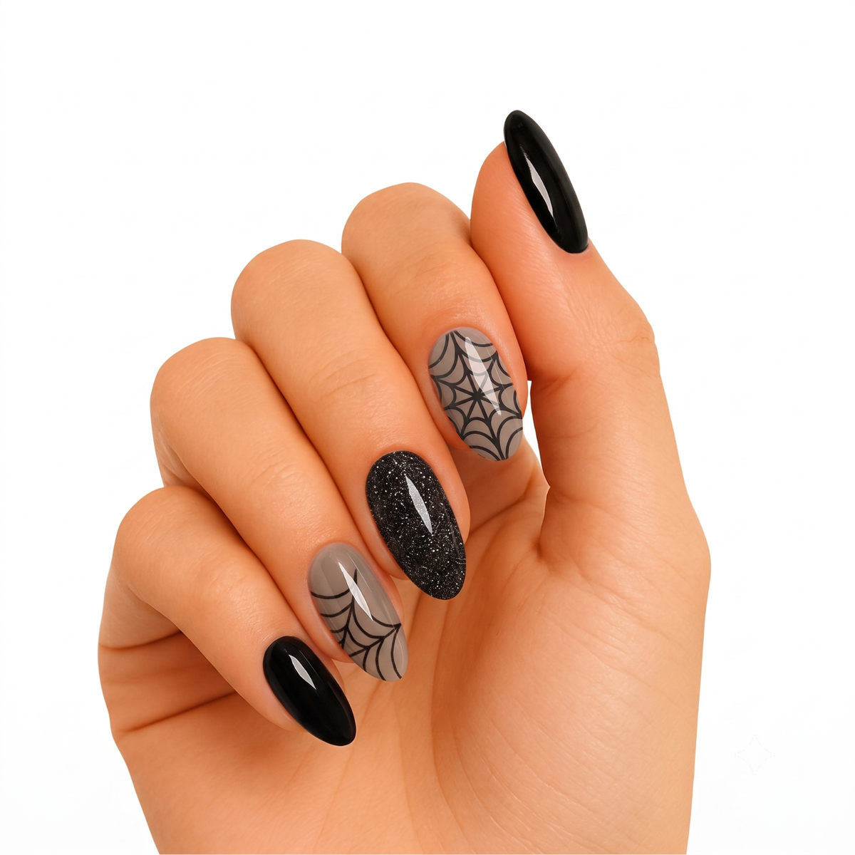Glossy black and nude press-on nails with black glitter accent and spiderweb designs.
