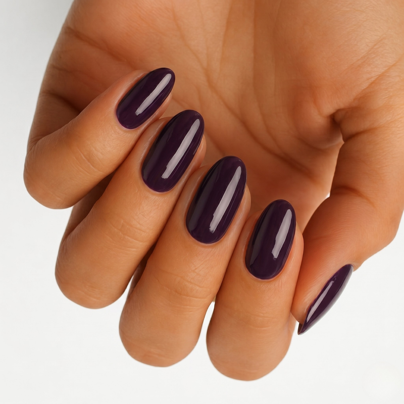 Deep plum purple glossy semi-cured gel nail wraps on almond-shaped nails