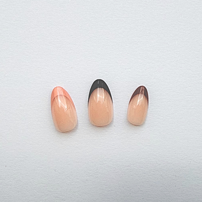 Press-on nails with sheer nude base and glossy orange-to-brown ombré tips