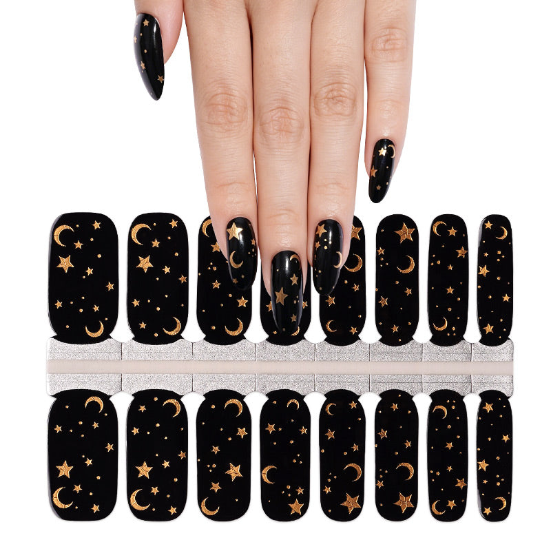 Black gloss nail wraps with gold moon and star celestial design