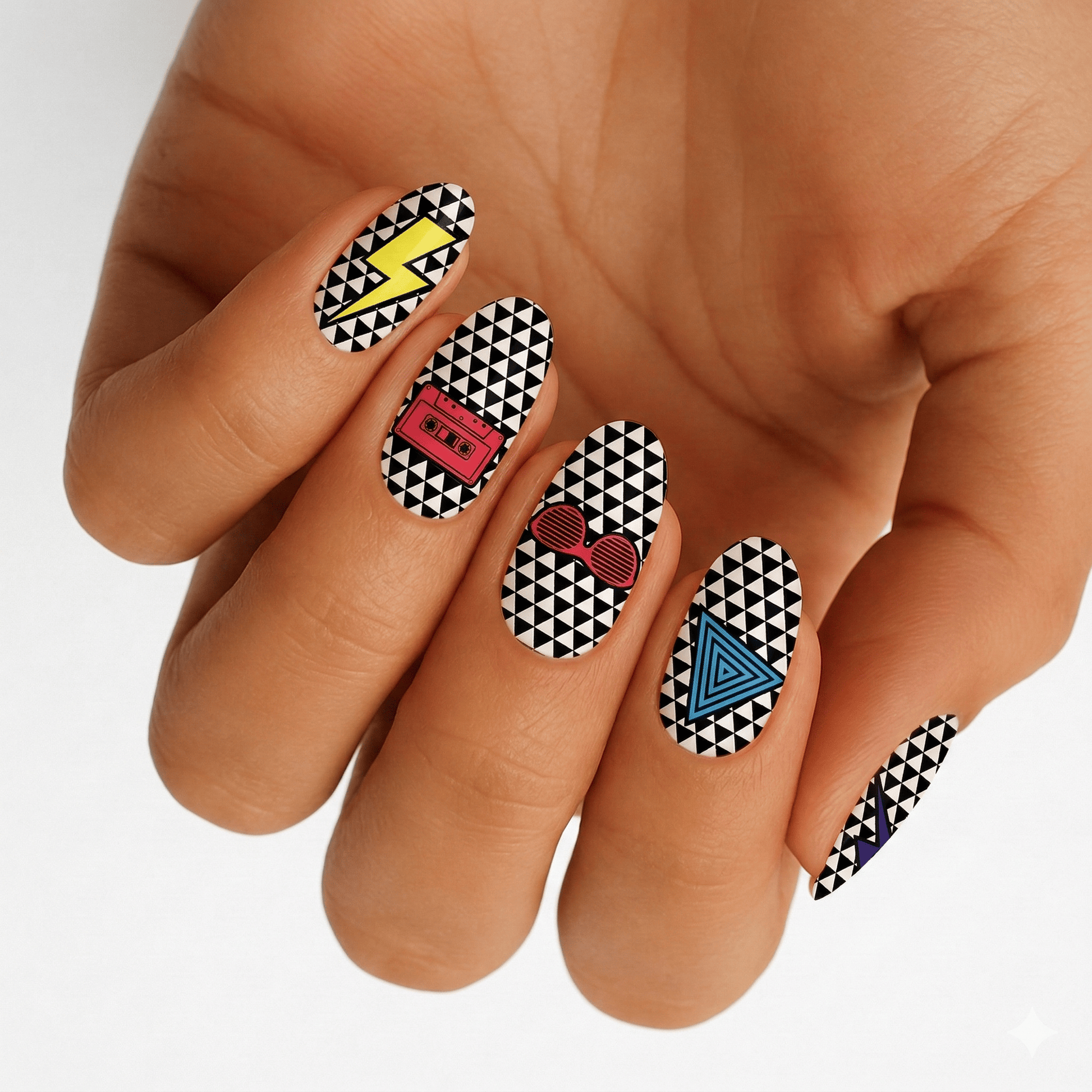 Hand displaying geometric black white nail wraps with colourful 80s retro triangle pattern design