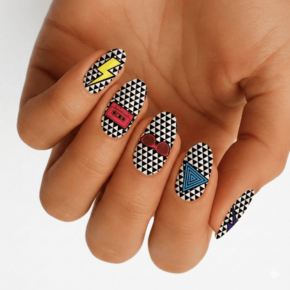 Hand displaying geometric black white nail wraps with colourful 80s retro triangle pattern design