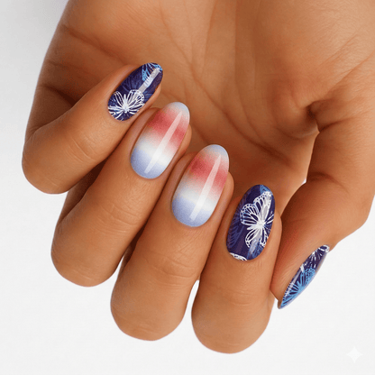 Blue butterfly nail wraps with gradient ombre design on hand showing at-home manicure