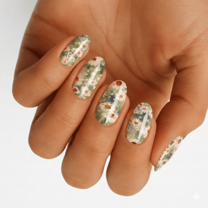 Hand wearing white nail wraps with green botanical daisy floral pattern designs
