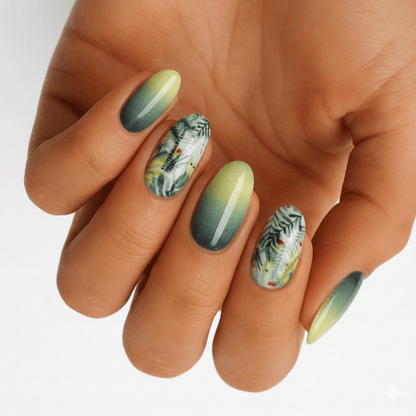 Green ombre gel nail wraps with botanical leaf pattern on hand for at-home manicure