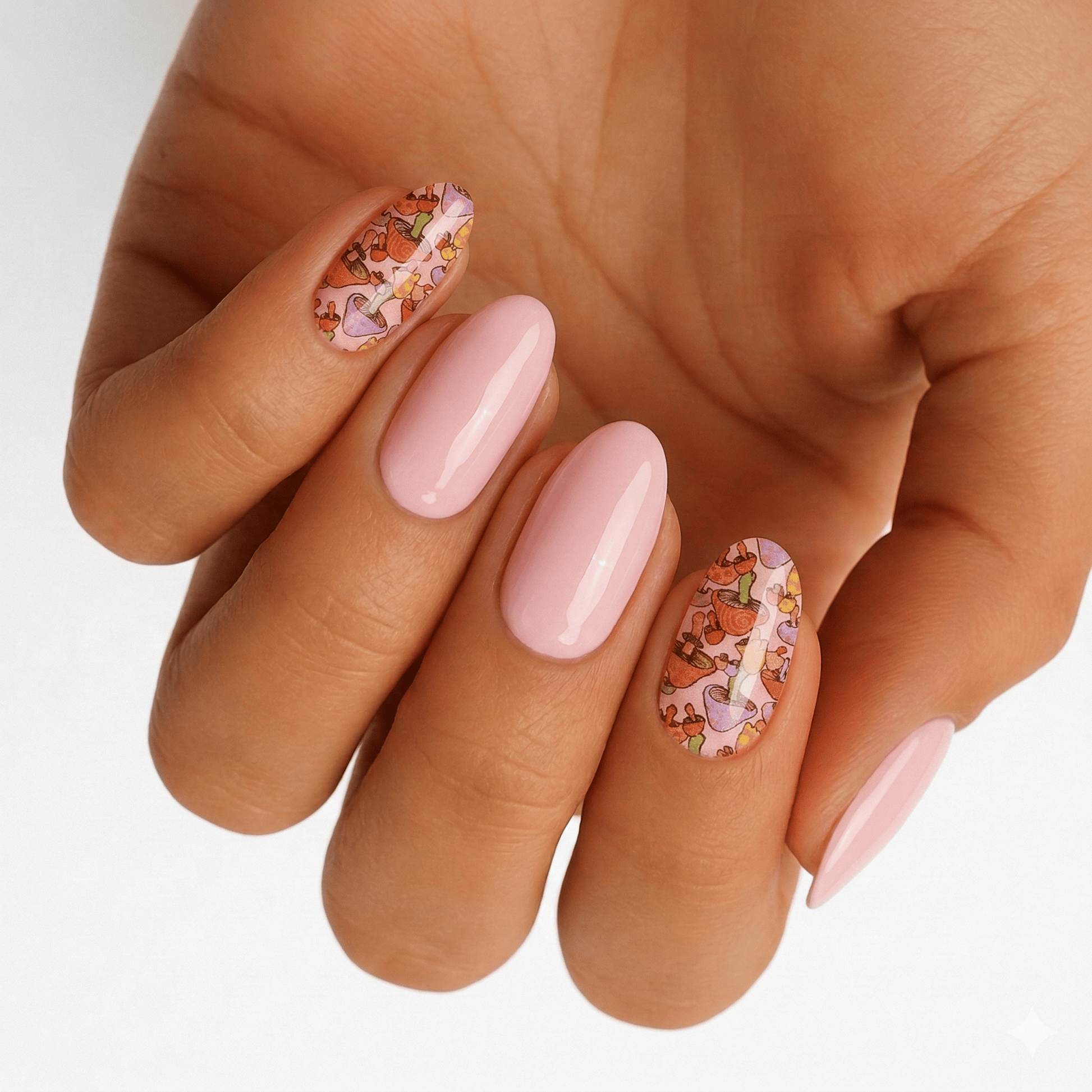 Pink fairytale mushroom nail art wraps on hand with botanical design