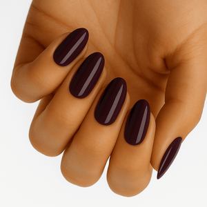 Hand displaying glossy deep mulberry purple nail wraps on all five fingers elegant manicure