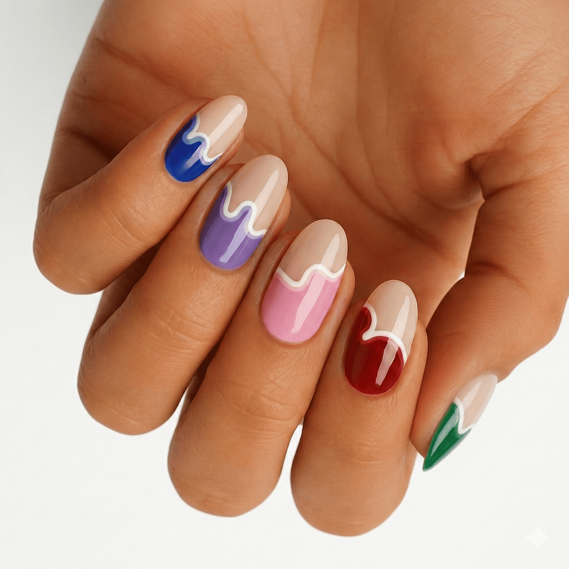 Multicoloured paint drip nail wraps on hand showing blue purple pink red green artistic design