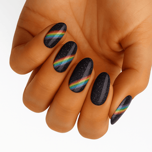 Black glitter nail wraps with rainbow holographic stripes on hand manicure