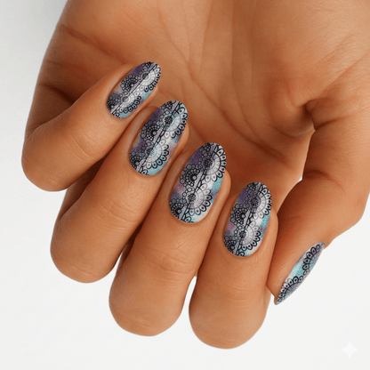 Grey marble nail wraps on hand with black and white swirled patterns