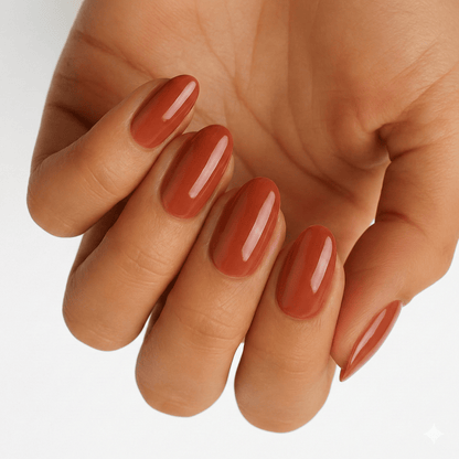 Hand showing rust orange wide fit nail wraps in glossy autumn terracotta shade