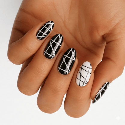 Black and white geometric nail wraps with crosshatch grid pattern on hand for edgy manicure