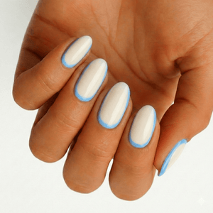 White nail wraps with powder blue French tips on hand elegant manicure design