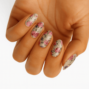 Vintage floral nail wraps with pink roses and botanical patterns on hand