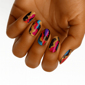 Colourful abstract nail wraps on hand featuring gold metallic and neon accents