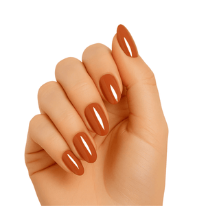 Burnt caramel brown glossy gel nail wraps on hand showing nude autumn manicure