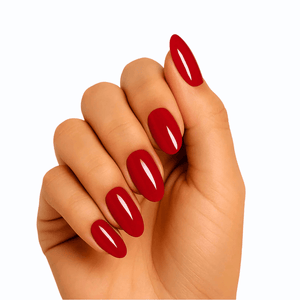 Hand wearing glossy red semi-cured gel nails in classic oval shape