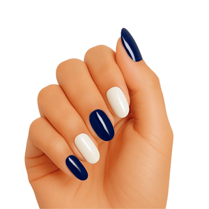 Navy blue and white gel nail wraps on hand showing glossy manicure finish