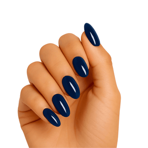Deep navy blue glossy gel nail wraps on hand showing oval manicure shape